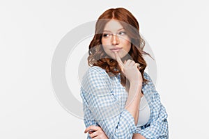 pensive redhead young woman in blue