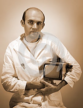 Pensive scientist with vintage monitor