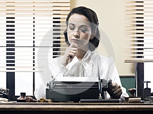 Pensive secretary with typewriter