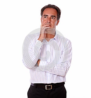 Pensive senior male on white shirt standing