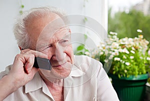 Pensive Senior Man With a Phone