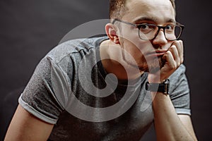 Pensive student leaning on his chin