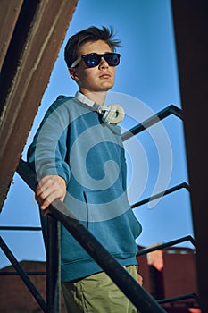 Pensive teenage boy with headphones