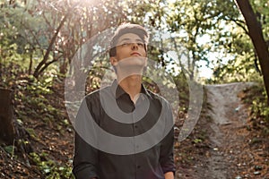 Pensive teenage boy looking up hoping