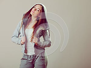 Pensive teenage girl in hooded sweatshirt. Fashion