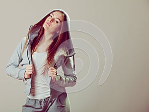Pensive teenage girl in hooded sweatshirt. Fashion