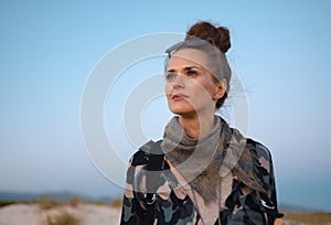 Pensive traveller woman looking into distance against blue sky