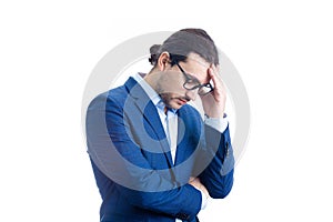 Pensive and upset businessman keeps hand to head looking stressed and bewildered isolated on white background. Man suffering
