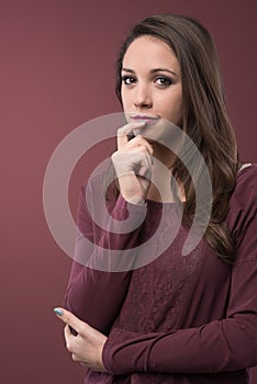 Pensive woman with hand on chin