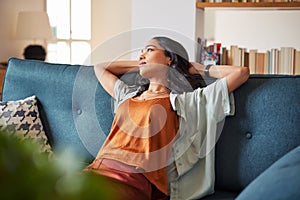 Pensive woman at home while looking up