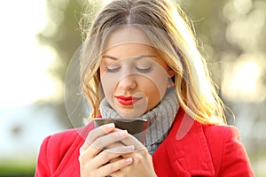 Pensive woman looking at a cup of coffee