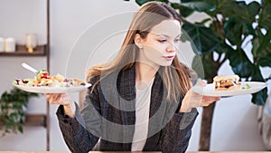 Pensive woman making decision between healthy food and fast food. healthy eating concept. business woman in a jacket
