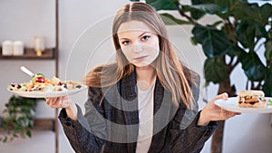 Pensive woman making decision between healthy food and fast food. healthy eating concept. business woman in a jacket