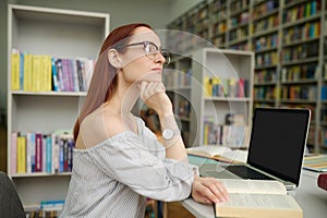 Pensive woman with open book looking to side