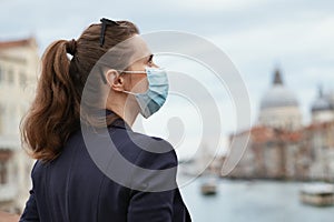 Pensive woman sightseeing on Accademia bridge in Venice, Italy