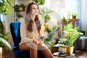 Pensive woman in sunny day using phone applications