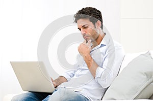 Pensive worried guy at laptop