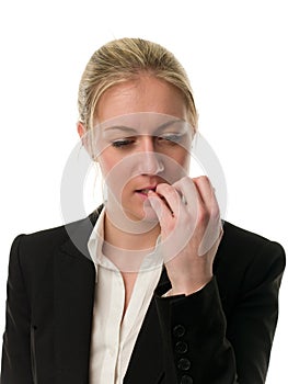 Pensive young businesswoman biting her nails