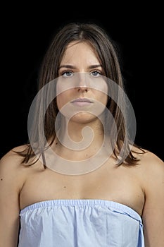 Pensive young girl on a black background