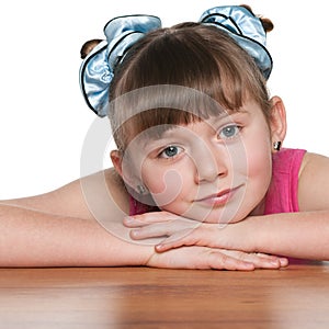 Pensive young girl at the desk