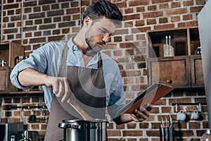 pensive young man cooking