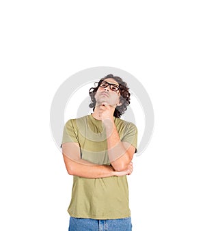 Pensive young man student or professor, long curly hair style wearing eyeglasses, keeps hand under chin, thoughtful gesture,