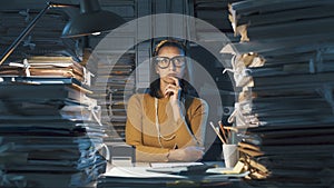 Pensive young office worker with hand on chin