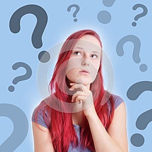 Pensive young woman with interrogation marks photo