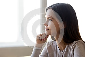 Pensive young woman look in distance thinking of future