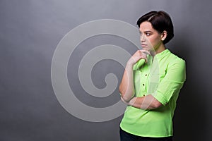 Pensive young woman looking away copy space