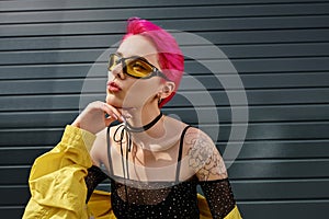 pensive young woman with pink hair