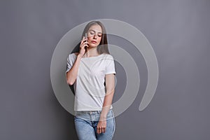 Pensive young woman talking on phone