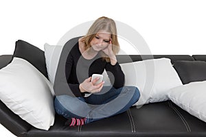 Pensive young woman is using her smart phone