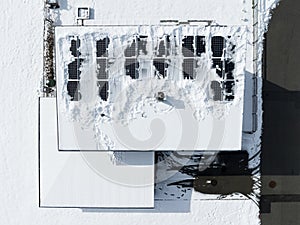 pent flat roof with snow freed photovoltaic panels