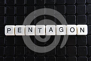 Pentagon title text word crossword. Alphabet letter blocks game texture background. White alphabetical letters on black