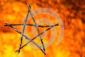 Pentagram of branches background Bokeâ€” five elements: Fire, Water, Air, Metal, Earth and Life. Pentacle symbol of the Goddess of