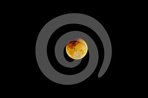 Penumbral eclipse ends of the moon on the dark night background photo