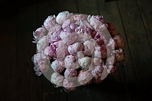 Peonies in a bouquet of flowers on a leg in the interior of the restaurant for a celebration shop floristry wedding salon