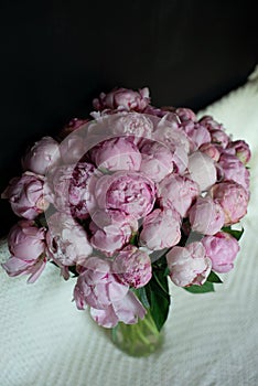 Peonies of flowers on a leg in the interior of the restaurant for a celebration shop floristry or wedding