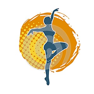 Silhouette of a female ballet dancer in action pose.