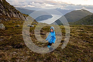 People, adult with kids and pet dog, hiking mount Hoven, enjoying the splendid view over Nordfjord from Loen skylift