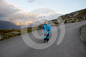 People, adult with kids and pet dog, hiking mount Hoven, enjoying the splendid view over Nordfjord from Loen skylift