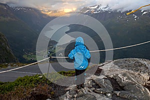 People, adult with kids and pet dog, hiking mount Hoven, enjoying the splendid view over Nordfjord from Loen skylift