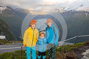 People, adult with kids and pet dog, hiking mount Hoven, enjoying the splendid view over Nordfjord from Loen skylift