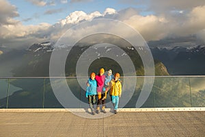 People, adult with kids and pet dog, hiking mount Hoven, enjoying the splendid view over Nordfjord from Loen skylift