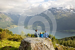 People, adult with kids and pet dog, hiking mount Hoven, enjoying the splendid view over Nordfjord from Loen skylift