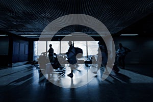 People at an airport terminal, waiting for departure time, motion blur shot