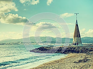 People along seagull obelisk at promenade