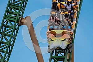 People amazing terrific Cheetah Hunt rollercoaster on lightblue cloudy sky background 90.