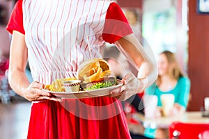 People in American diner or restaurant eating fast food